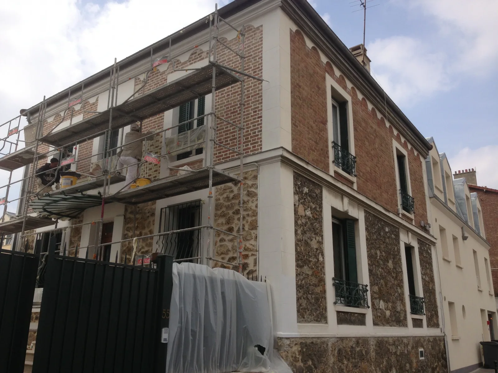 Déjointoiement et rejointoiement de la brique et de la pierre sur un chantier de ravalement à Puteaux